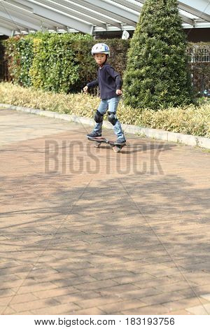 Japanese Boy Riding On A Casterboard (first Grade At Elementary School)
