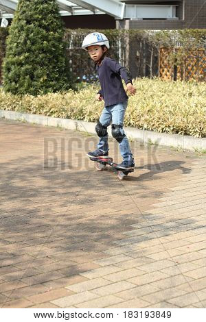Japanese Boy Riding On A Casterboard (first Grade At Elementary School)