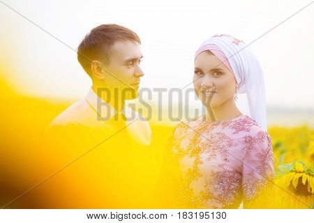 Smiling Young Islamic Couple Portrait On Sunflowers Field