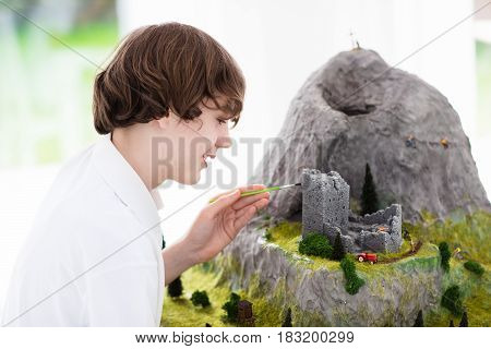 School Student Working On Model Building Project