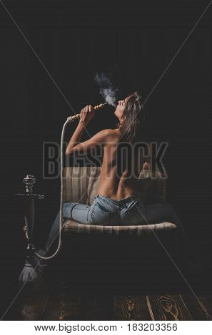 Sexy Girl With Naked Body Smoking Hookah In Jeans