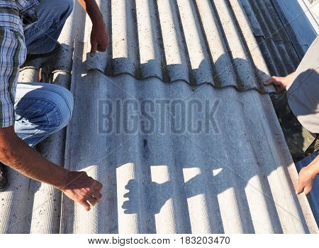Roofer Repair and Replace Dangerous Asbestos Old Roof Tiles. Asbestos removal.