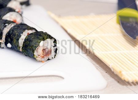 homemade sushi rolls on a white cutboards