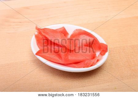 plate with Japanese pickled ginge on wood background