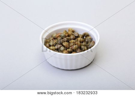 bowl with fresh capers isolated on white background
