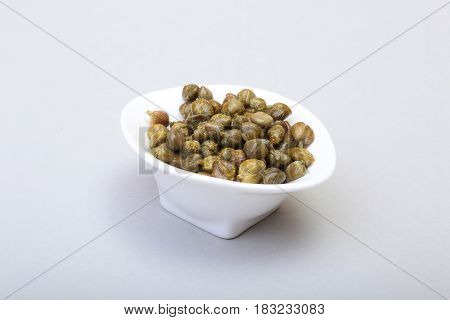 bowl with fresh capers isolated on white background