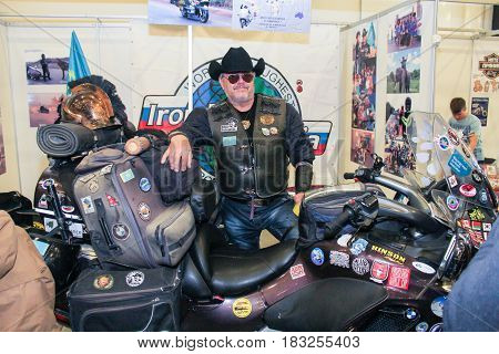 St. Petersburg Russia - 15 April, The biker is at his bike,15 April, 2017.
International Motor Show IMIS-2017 in Expoforurum.
Visitors and participants of the annual moto-salon in St. Petersburg.