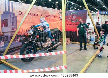 St. Petersburg Russia - 15 April, A swing from a motorcycle,15 April, 2017.
International Motor Show IMIS-2017 in Expoforurum.
Visitors and participants of the annual moto-salon in St. Petersburg.