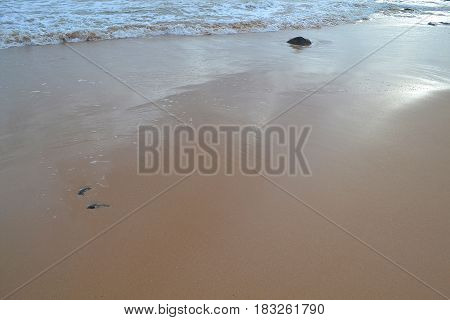 Bubbles waves on the sand beach texture background