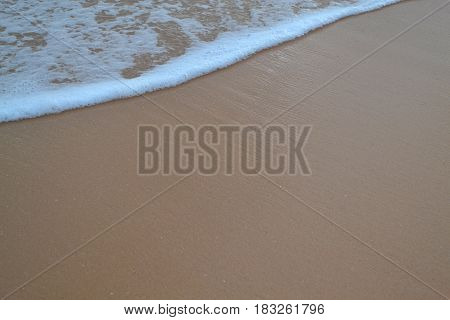 Bubbles waves on the sand beach texture background