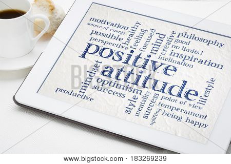 positive attitude and mindset word cloud on a digital tablet with a cup of coffee