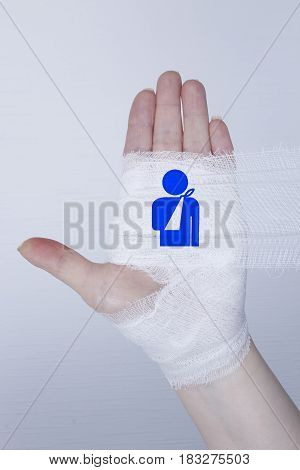 White medical dressing on a traumatized female hand