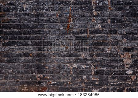 Background of old vintage dirty brick wall with peeling plaster texture.