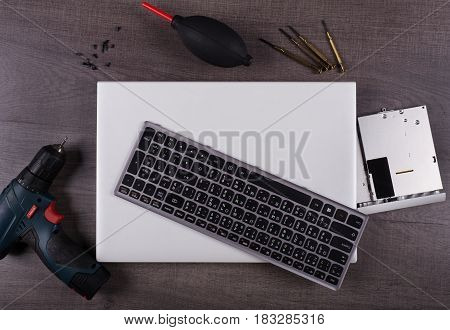 Computer Notebook With Coponent And Tool (repair Concept) On Wood Background