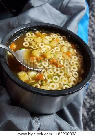 Instant oup with vegetables and noodles in a small coup