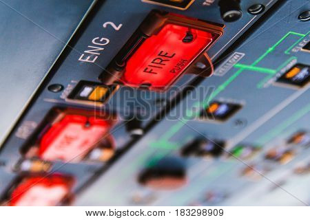 Fire pushbuttons and warning lights on the overhead panel in a cockpit. Bright red warning lights come on when a fire is detected in one of the engines or the APU.
