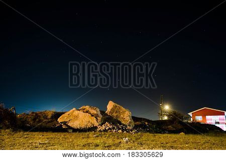 Rock in the night accompanied by rocks