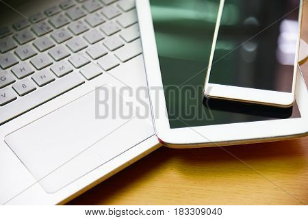 laptop computer notebook with smarth phone and taplet on wooden desk in business office