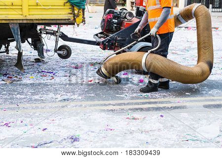 Street cleaner with industrial vacuum cleaner. Municipal cleaning service, clean streets