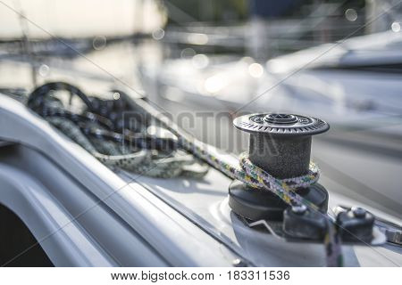 Capstan with line on a sailboat with white background.