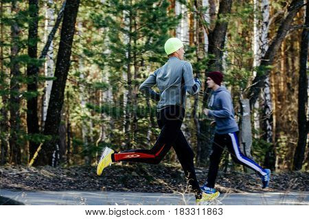 Chelyabinsk Russia - April 22 2017: two runners men running each other in Spring half marathon