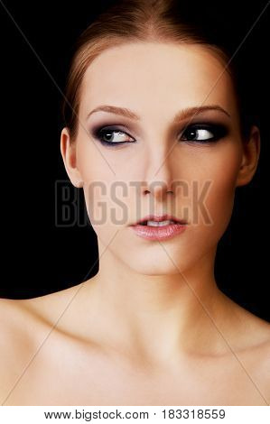 Attractive blonde topless woman with dark make up