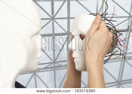  Cyborg, clone, robot and artificial man concept -  android robot holds clone white face mask