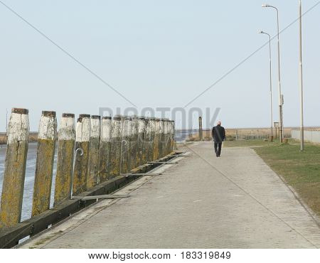 Tourist walking on the pier of Noordpolderzijl. The Netherlands