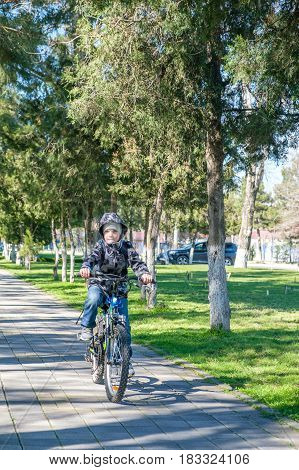 boy riding a bike in the park.