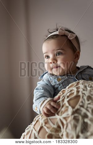 Detail of a mother holding in her arms an adorable smiling baby girl