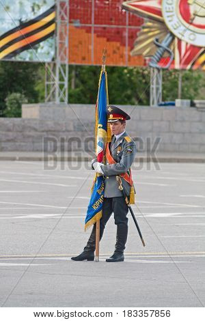 Volgograd Russia - May 07 2012: Lone standard-bearer with flag at the dress rehearsal of Military Parade on 67th anniversary of Victory in Great Patriotic War on Victory day in Volgograd