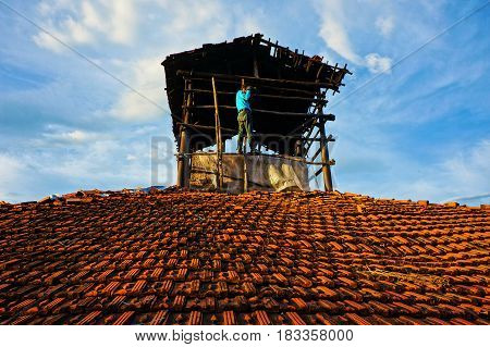 Amazing scene with Asian man photographer stand on roof and take photo under sky manly and personality male when climb high with camera people take photo with passion