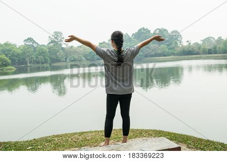Happy woman feeling free in a beautiful nature - outdoor concept