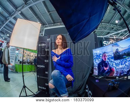 MOSCOW RUSSIA - APRIL 21 2017: Booth of Sigma company with workplace for testing lenses at PhotoForum 2017 trade show and exhibition in Moscow Russia on April 21 2017.