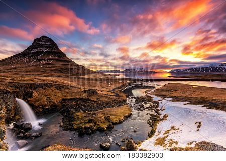 Spring Sunrise Over The Famous Kirkjufellsfoss Waterfall With Kirkjufell Mountain In The Background