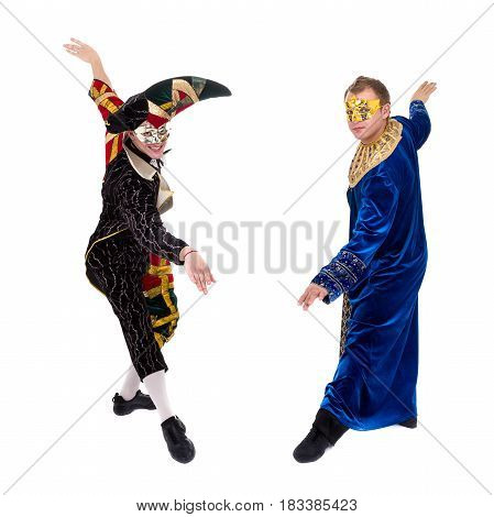 Smiling harlequin and pierrot wearing a mask, isolated on white background in full length.