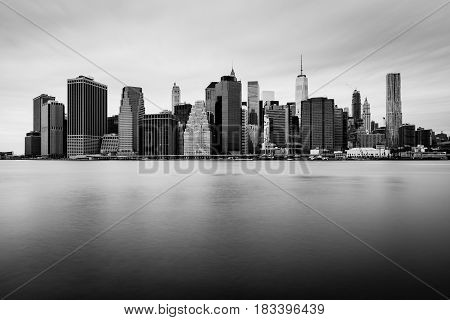 Manhattan downtown skyline in cloudy day, black and white colors, New-York, USA
