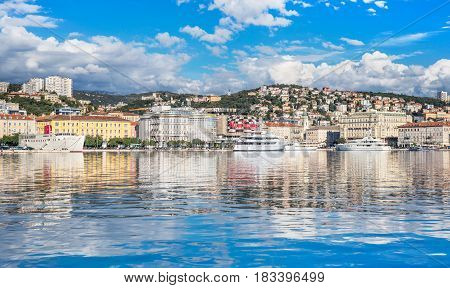 Rijeka - June of 2012, Croatia: View of Rijeka harbor with white ships at the pier, skyline of the city center, sunny day, blue sky with clouds