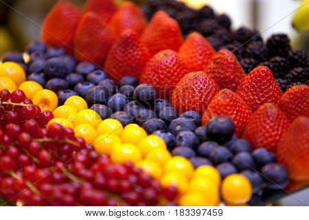 Variety of fresh fruit assortment of raspberries strawberries blueberries currants