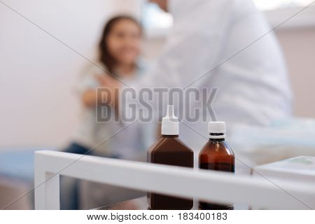 Aseptic liquid. Selective focus of two bottles with aseptic liquid standing in the rheumatologists office