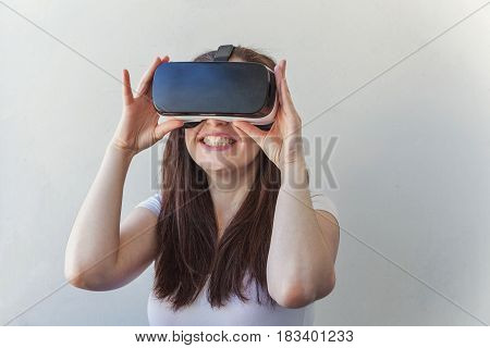 Smile happy young woman using the virtual reality headset on white background