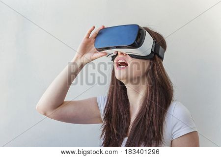 Smile happy young woman using the virtual reality headset on white background