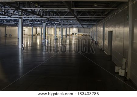 A huge empty warehouse is filmed in the twilight