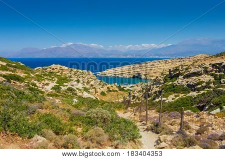Natural hiking path leading towards the Red Beach in Greece