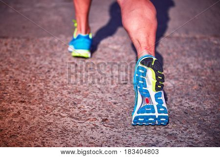 Running athlete during training outdoors in the summer on a sunny day.