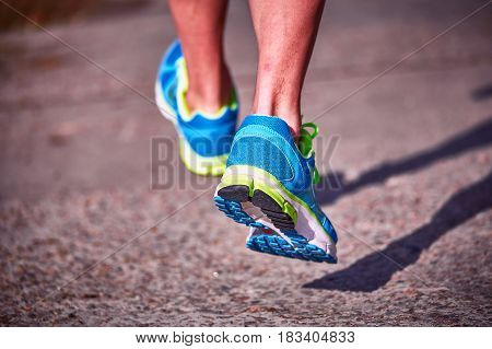 Running athlete during training outdoors in the summer on a sunny day.