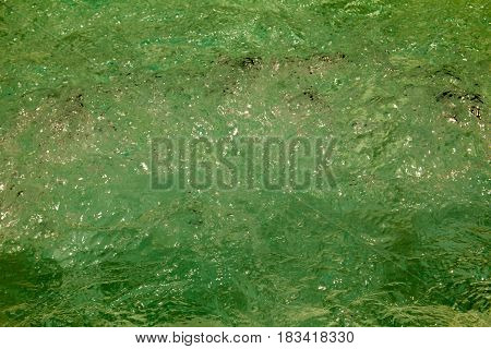 Clear background swimming pool rippled water detail.
