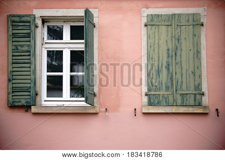 Old wooden and fading window shutters on a nostalgic window.
