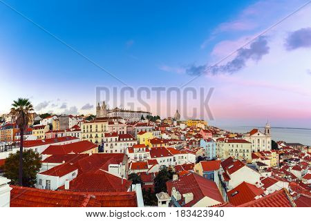 Panoramic view of Alfama, the oldest district of the Old Town, with Monastery of Sao Vicente de Fora, Church of Saint Stephen and National Pantheon dat sunset, Lisbon, Portugal