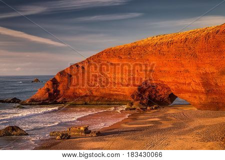 Sunset at red arches of Legzira beach, Sidi Ifni, Souss-Massa-Draa, Morocco.